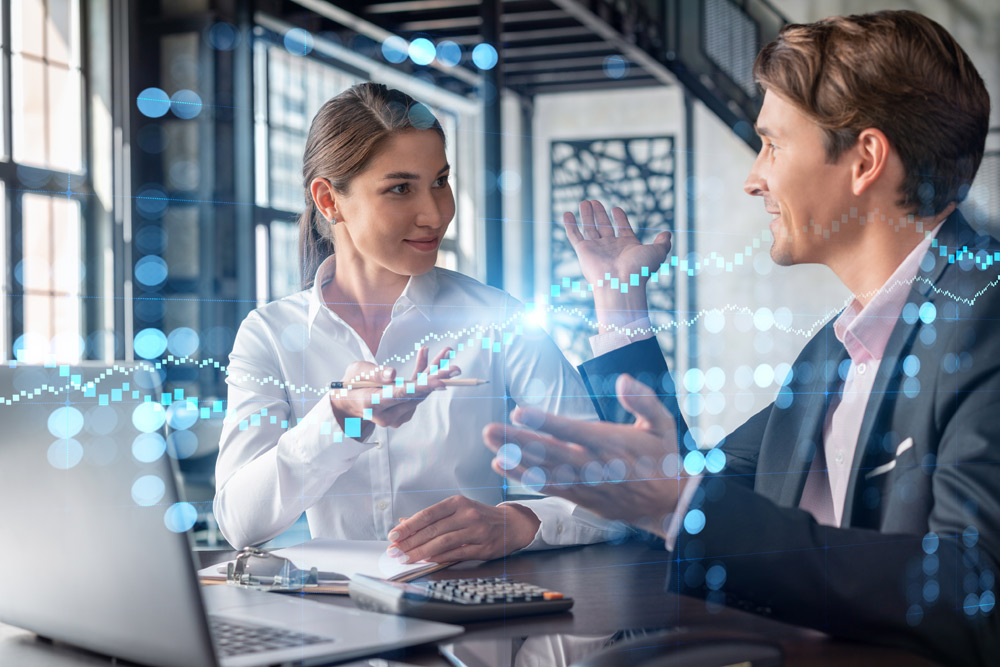colleagues discussing in front of a laptop computer