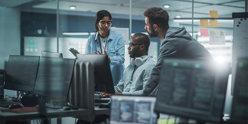 software engineers discuss in a computer lab