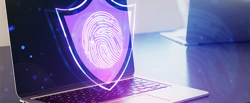 laptop with a shield and fingerprint overlay icon