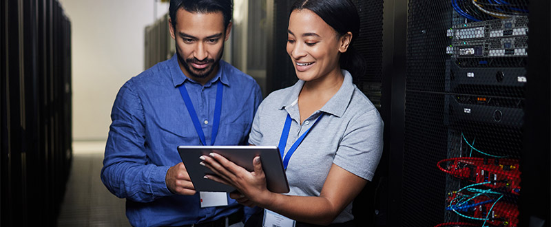 two technicians review a tablet screen